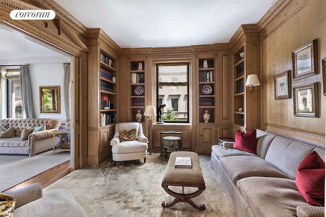 living area with wood walls and built in features