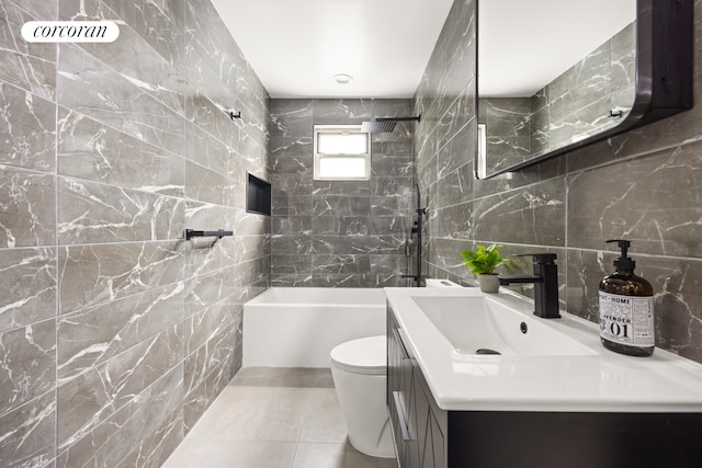 full bathroom featuring toilet, tile walls, vanity, and shower / tub combination