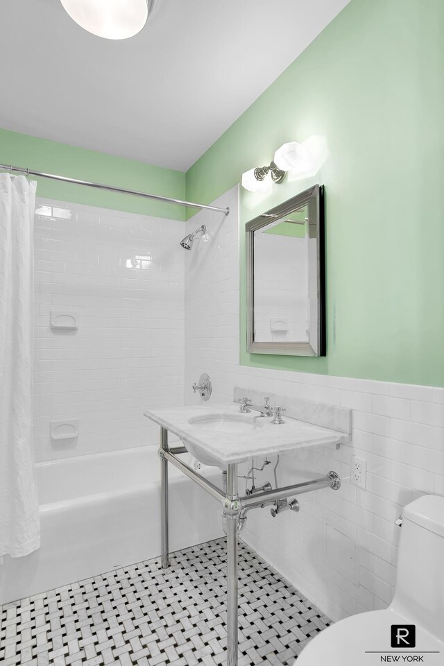 30 Main St Unit 11-G, New York City, NY 11201 - full bathroom with toilet, shower / bath combination with curtain, tile walls, and a wainscoted wall