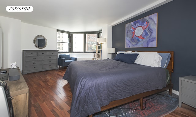 bedroom with dark hardwood / wood-style floors