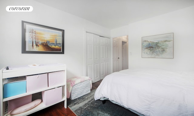 bedroom with dark hardwood / wood-style flooring