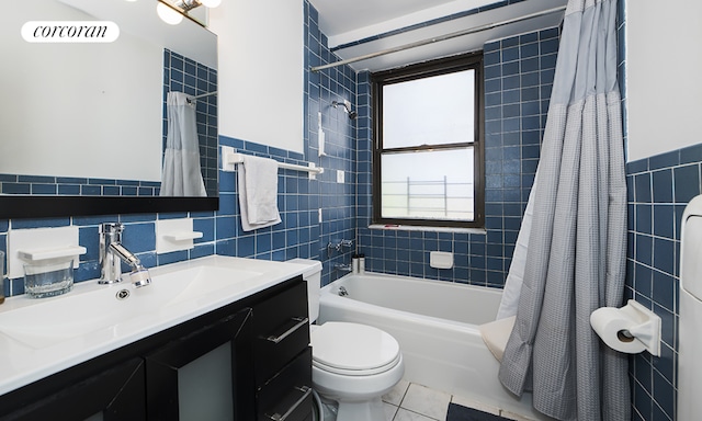 full bathroom with tile patterned flooring, shower / tub combo, tile walls, and toilet