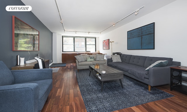 living room featuring dark wood-type flooring and rail lighting