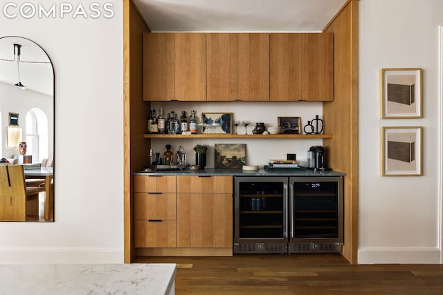 bar featuring dark hardwood / wood-style floors and wine cooler