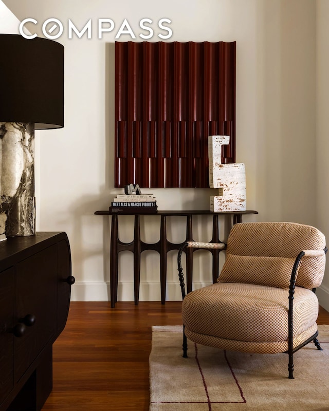 living area featuring wood finished floors and baseboards