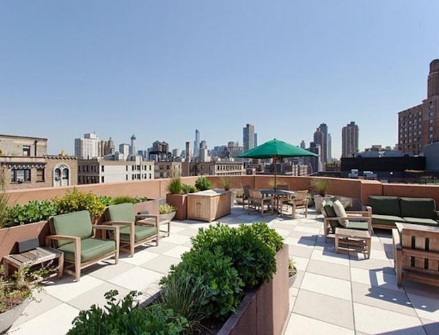 view of patio / terrace with a view of city and outdoor lounge area