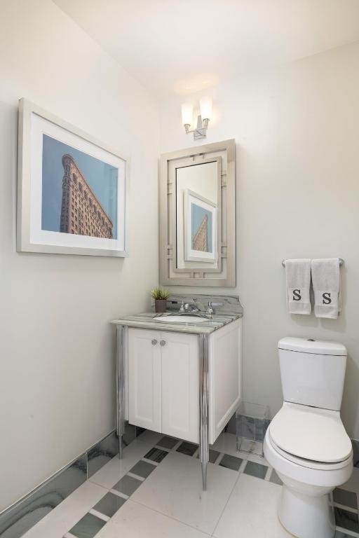 bathroom with tile patterned floors, toilet, and vanity