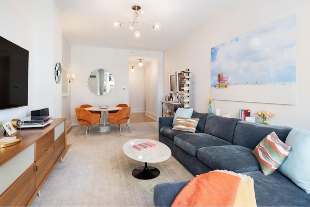 living room featuring an inviting chandelier and baseboards