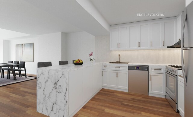 170 E End Ave Unit 2G, New York City, NY 10128 - kitchen with a sink, appliances with stainless steel finishes, a peninsula, and white cabinetry