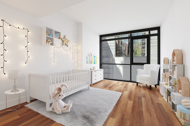 170 E End Ave Unit 2G, New York City, NY 10128 - bedroom featuring a crib, floor to ceiling windows, baseboards, and wood finished floors