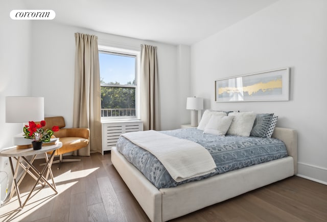 bedroom with dark wood-type flooring