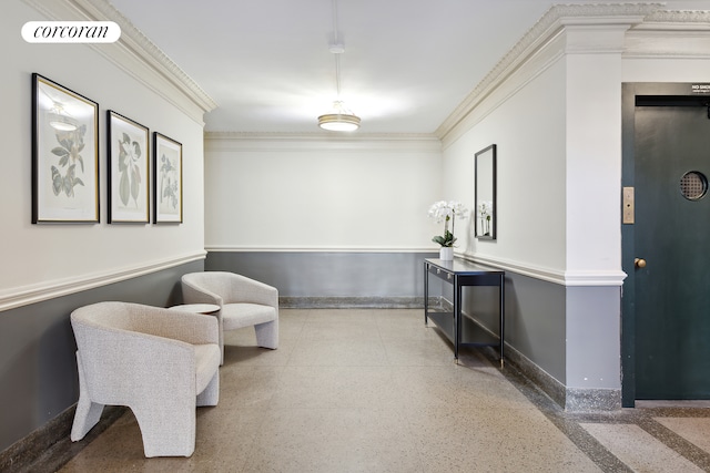 sitting room featuring visible vents, baseboards, ornamental molding, elevator, and speckled floor