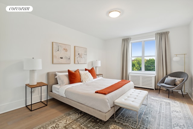 bedroom with visible vents, baseboards, and wood finished floors