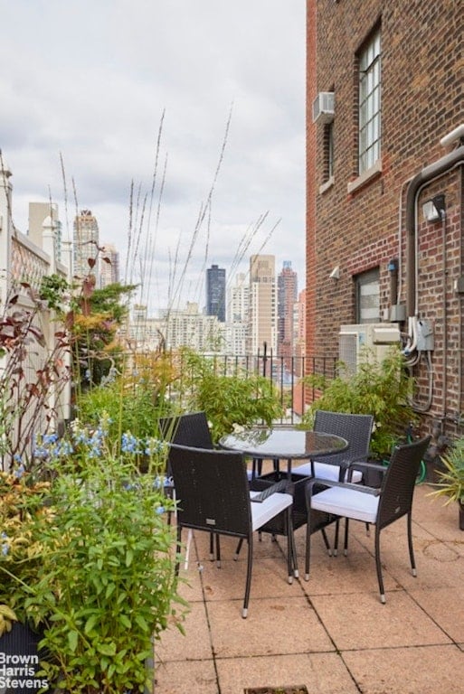 view of patio / terrace featuring an AC wall unit