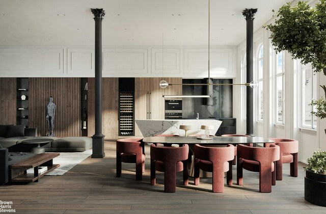 dining room featuring a wall of windows, track lighting, and hardwood / wood-style floors