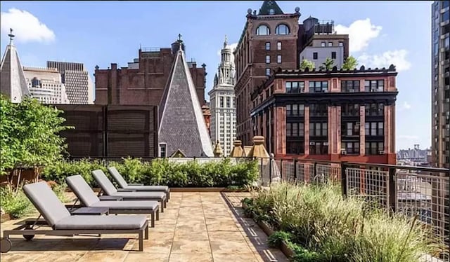 surrounding community featuring a patio area and a city view