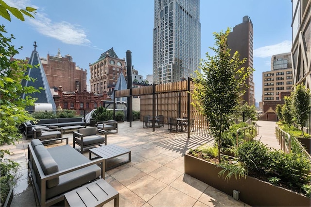 view of patio / terrace with a view of city, outdoor lounge area, and fence