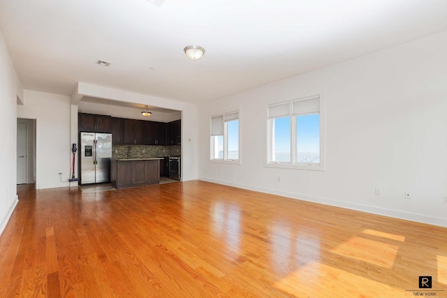 unfurnished living room featuring light wood-type flooring