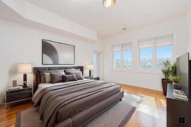 bedroom with hardwood / wood-style floors