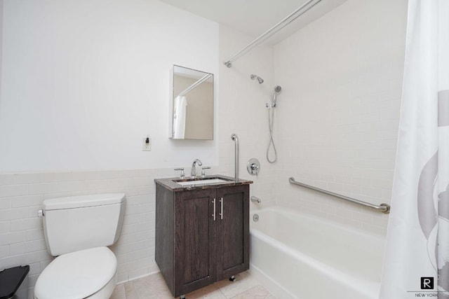 full bathroom with toilet, tile walls, vanity, shower / bath combo with shower curtain, and tile patterned flooring