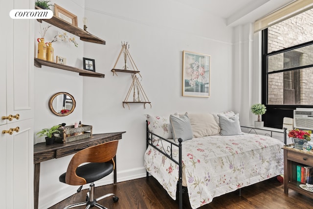 bedroom with dark hardwood / wood-style floors