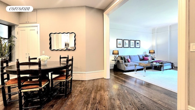 dining room with dark hardwood / wood-style flooring