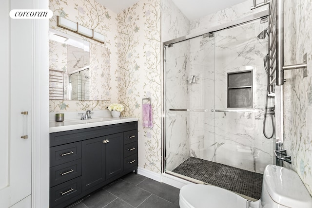 bathroom featuring toilet, vanity, tile patterned flooring, and an enclosed shower