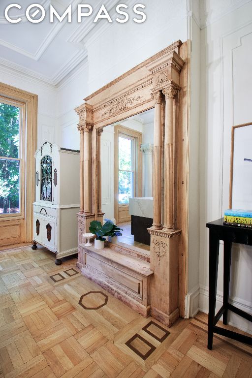 interior space featuring decorative columns and light parquet flooring