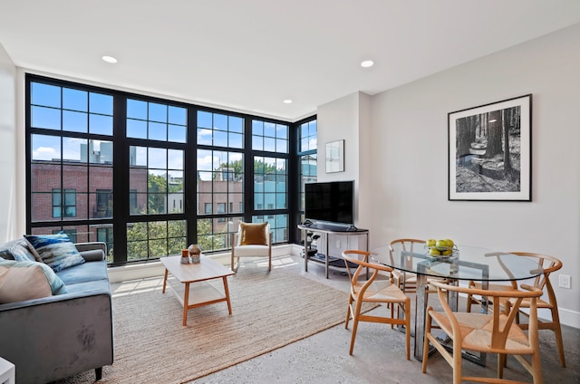 living room with recessed lighting and a towering ceiling