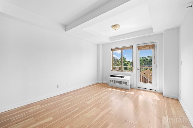 empty room with light hardwood / wood-style floors and heating unit