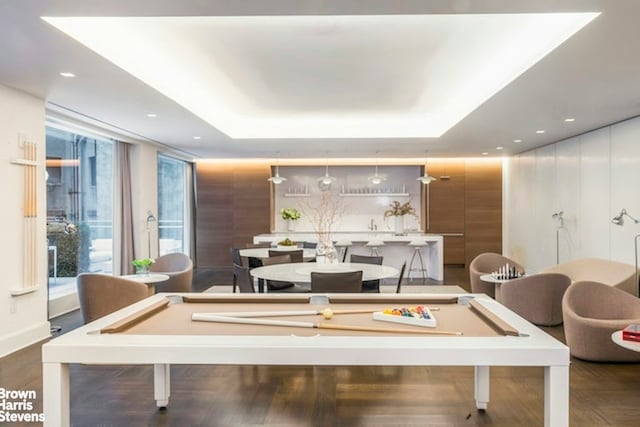 recreation room with billiards, a raised ceiling, wood finished floors, and recessed lighting