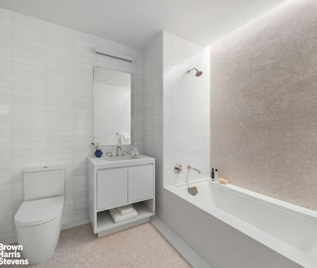 full bath featuring shower / bath combination, tile walls, toilet, and vanity