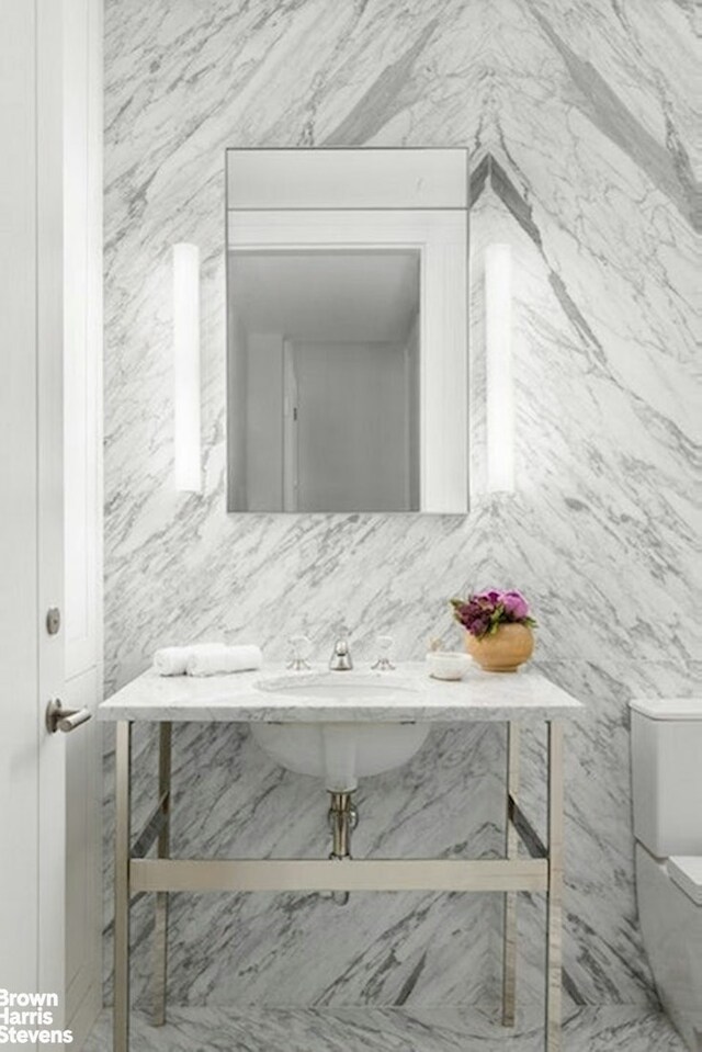 bathroom featuring backsplash and toilet