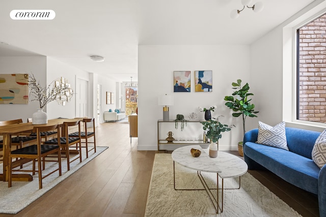 living room featuring baseboards, visible vents, and light wood-style floors