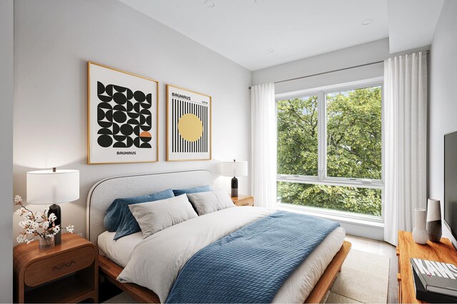 living room with a wealth of natural light and light hardwood / wood-style flooring