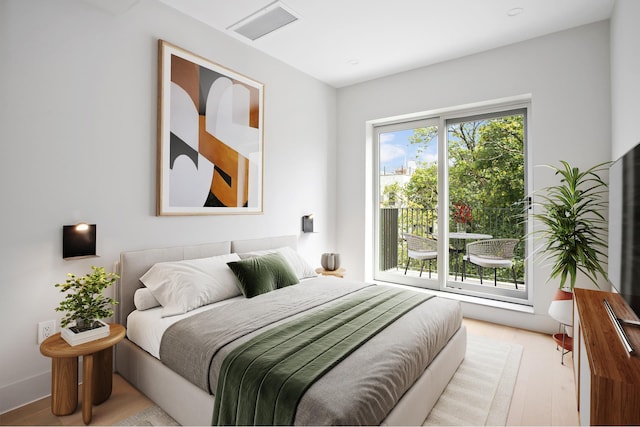 bedroom with wood finished floors and visible vents