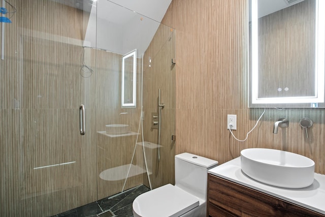 full bath featuring toilet, tile walls, marble finish floor, a shower stall, and vanity