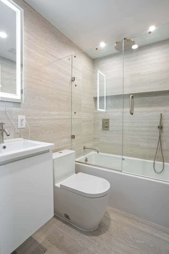 bathroom with toilet, vanity, and bathtub / shower combination