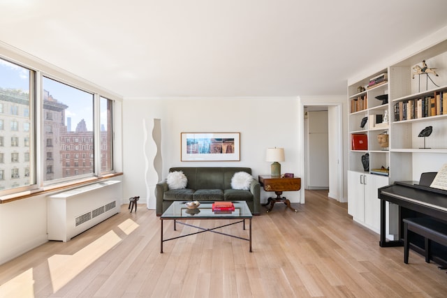 living room featuring light hardwood / wood-style floors and radiator