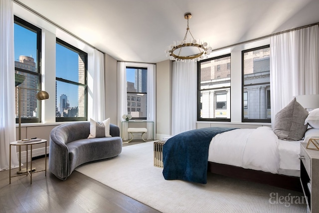 bedroom with hardwood / wood-style flooring and a notable chandelier