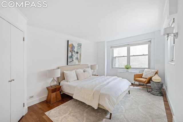 bedroom featuring hardwood / wood-style flooring and ornamental molding