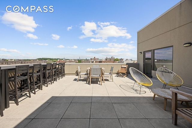 view of patio / terrace with a view of city and outdoor dry bar