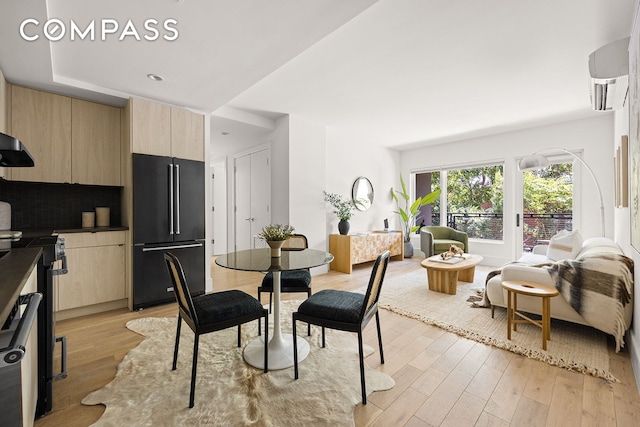 dining space with light wood-style flooring