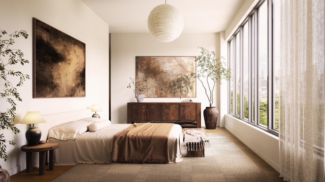 bedroom with baseboards and wood finished floors