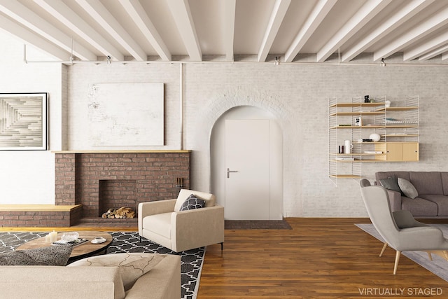 living area with beamed ceiling, a fireplace, and wood finished floors