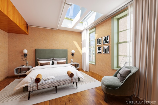 bedroom with hardwood / wood-style floors and a skylight