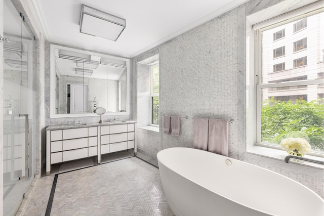 bathroom featuring vanity, a freestanding tub, a shower with shower door, and crown molding