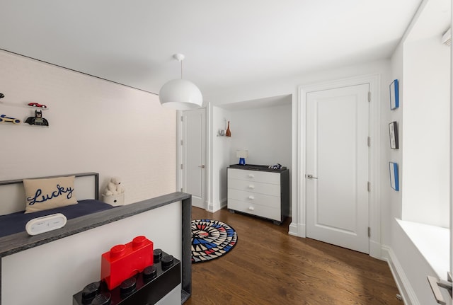 bedroom featuring dark wood-type flooring and baseboards