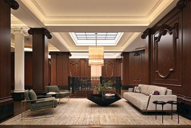 living room featuring hardwood / wood-style flooring, ornamental molding, and a tray ceiling