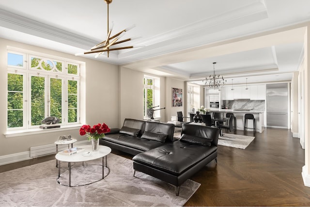 living room with a raised ceiling, a chandelier, crown molding, baseboards, and baseboard heating